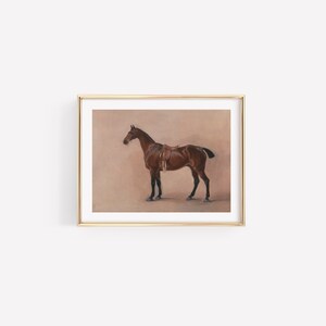 May include: A framed painting of a brown horse with a saddle, standing on a light brown background.