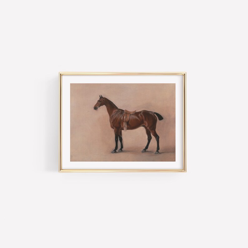 May include: A framed painting of a brown horse with a saddle, standing on a light brown background.