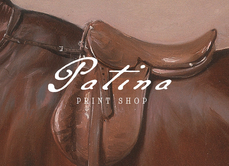 May include: A brown leather saddle with the text "Patina Print Shop" in white lettering.