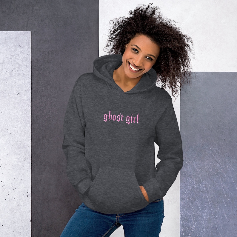 May include: A dark gray hooded sweatshirt with the words "ghost girl" embroidered in pink on the front.