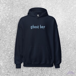 May include: A navy blue hooded sweatshirt with the text "ghost boy" in a light blue gothic font.