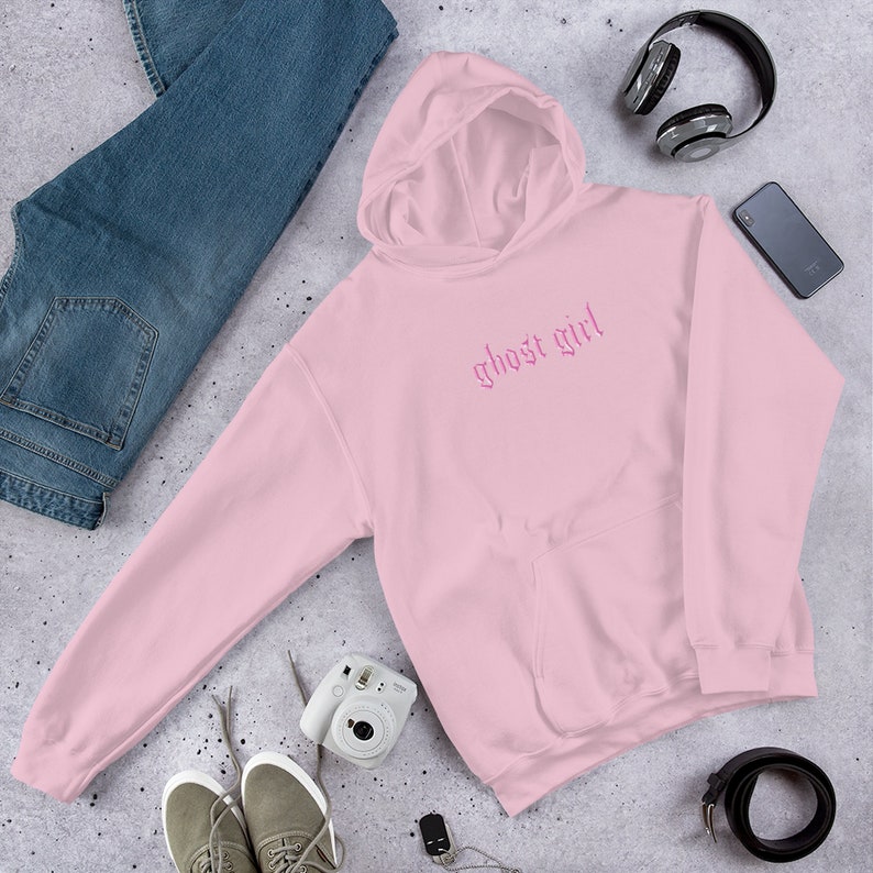 May include: Pink hooded sweatshirt with the text "ghost girl" in pink gothic lettering.