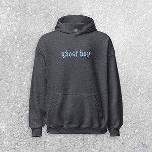 May include: A dark gray hooded sweatshirt with the text "ghost boy" embroidered in light blue on the front.