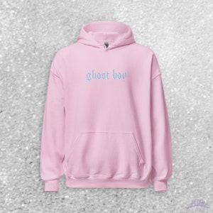 May include: A pink hooded sweatshirt with the text "ghost boy" in blue embroidered on the front.