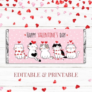 May include: Printable Valentine's Day chocolate bar wrapper featuring five cartoon cats wearing red heart garlands. The wrapper is pink with white hearts and the text "Happy Valentine's Day".