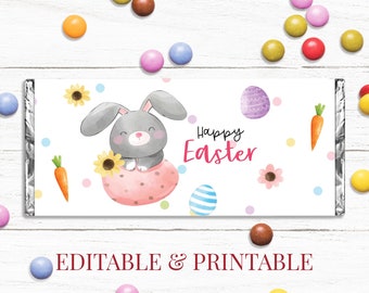 May include: Printable Easter chocolate bar wrapper featuring a cute cartoon bunny holding a sunflower in a pink egg. The wrapper has a white background with colorful polka dots and the text "Happy Easter".