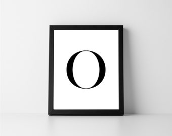 May include: Black and white printable art print featuring the letter "O" in a bold, modern font. The print is framed in a black frame.