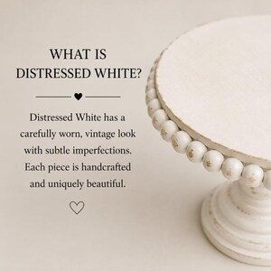 May include: A white pedestal cake stand with a distressed finish and a beaded rim. The text reads: WHAT IS DISTRESSED WHITE? Distressed White has a carefully worn, vintage look with subtle imperfections. Each piece is handcrafted and uniquely beautiful.