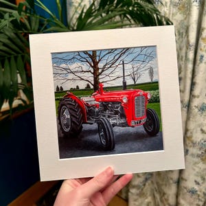 May include: A red vintage tractor with a black license plate that reads "BTY 305" is parked in a field. The tractor is surrounded by green grass and trees. The sky is blue with white clouds.