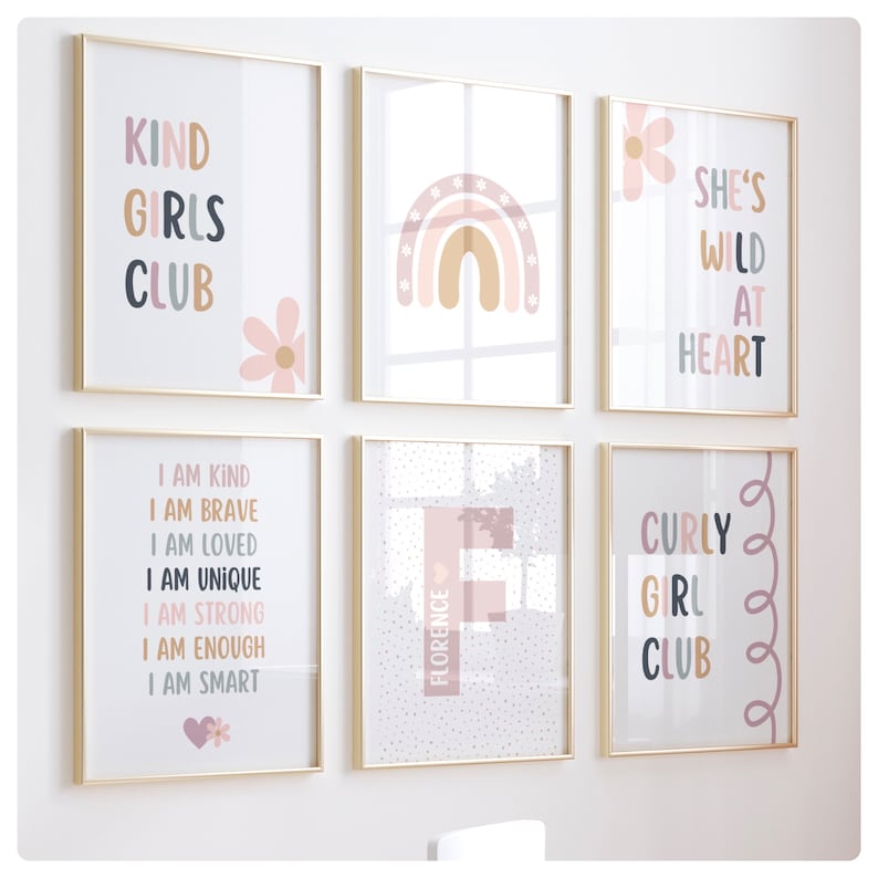 May include: Set of six framed prints with inspirational quotes and illustrations. The prints feature a rainbow, a flower, and text such as "Kind Girls Club", "She's Wild at Heart", and "Curly Girl Club".