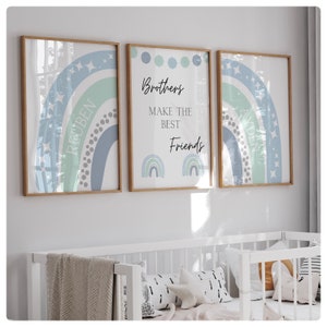 May include: Three framed prints with a blue and green rainbow design. The center print has the text "Brothers make the best friends" with two smaller rainbows below. The left and right prints have the names "Reuben" and "Aiden" written inside the rainbows.