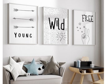 May include: Three black and white framed prints with inspirational words. The first print says "Young" with three arrows pointing to the right. The second print says "Wild" with a lightning bolt. The third print says "Free" with a peace sign and stars.
