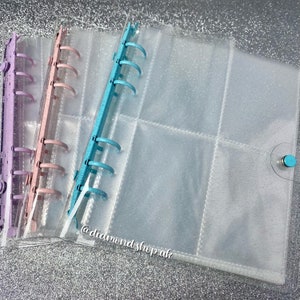 May include: Three clear plastic binder covers with different colored rings. The covers have a glittery finish and are designed to hold loose leaf paper. The text '@diamond_shop_uk' is visible on the bottom right corner of the image.