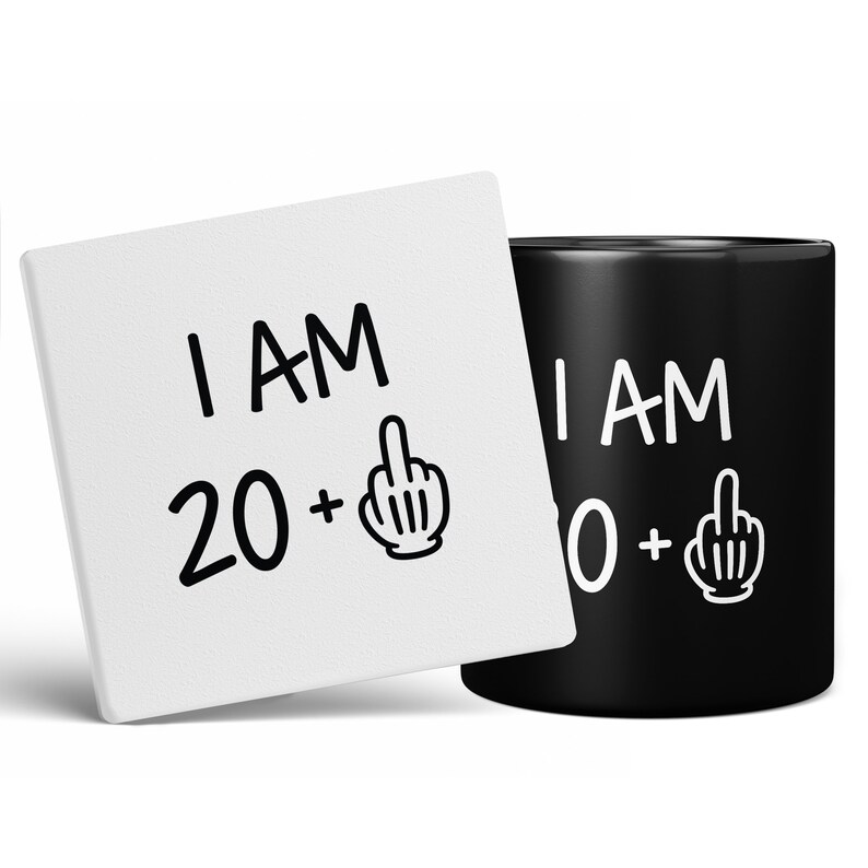 May include: A white ceramic coaster and a black ceramic mug with the text "I AM 20+" and "I AM 30+" with a middle finger emoji on each.