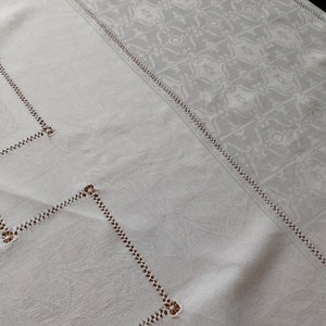 An antique French fine linen damask tablecloth with drawn threadwork embroidery.  Would benefit from some small repairs.  Superb quality.