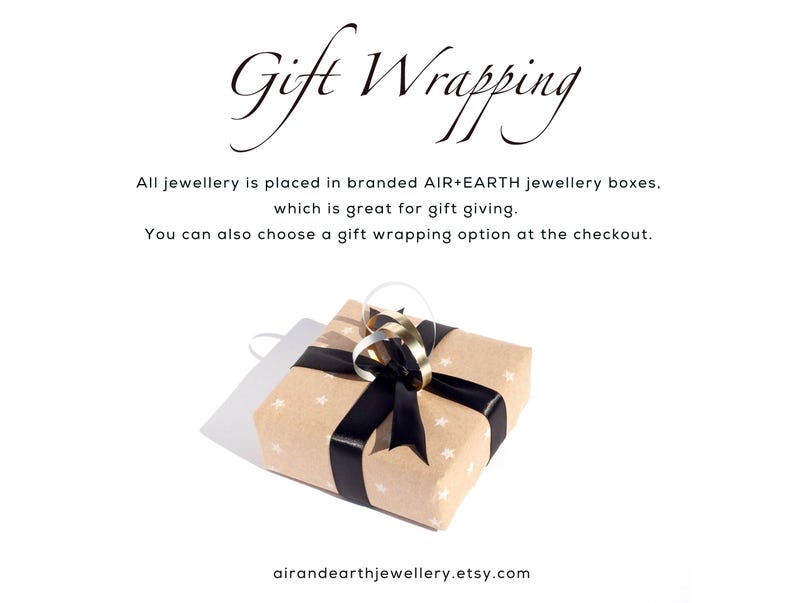 May include: A brown gift box with white stars and a black ribbon. The text "Gift Wrapping" is at the top of the image. The text "All jewellery is placed in branded AIR+EARTH jewellery boxes, which is great for gift giving. You can also choose a gift wrapping option at the checkout." is below the image. The text "airandearthjewellery.etsy.com" is at the bottom of the image.