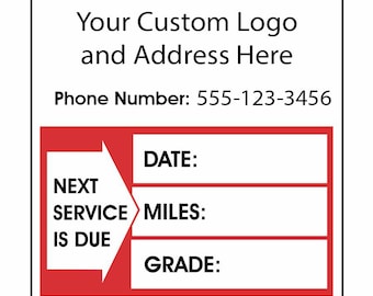 May include: A red and white sticker with a black arrow pointing to the right. The sticker has the text "Next Service Is Due" and fields for "Date", "Miles", and "Grade". The sticker also includes the text "Your Custom Logo and Address Here" and "Phone Number: 555-123-3456".