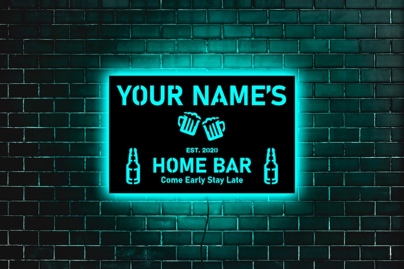 May include: A black neon sign with white text that reads "YOUR NAME'S HOME BAR EST. 2020 Come Early Stay Late". The sign is illuminated with a bright turquoise light and features a graphic of two beer mugs and two beer bottles.