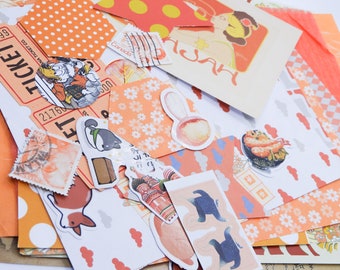 Könnte beinhalten: Eine Sammlung von orangefarbenen und weißen gemusterten Papieren, Aufklebern und Briefmarken. Die Papiere zeigen verschiedene Designs, darunter Punkte, Blumen und Wolken. Die Aufkleber beinhalten ein Cartoon-Kaninchen, eine Cartoon-Katze und eine Cartoon-Speiseschale. Die Briefmarken sind größtenteils vintage und zeigen verschiedene Designs.