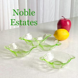 Könnte beinhalten: Set aus vier grünen Glasschalen mit Griffen. Die Schalen sind von Noble Estates.