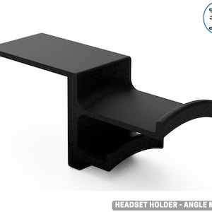 May include: A black headset holder, 3D-printed with an angled design. It has a flat top and a curved cradle. The text "HEADSET HOLDER - ANGLE MOUNT" is at the bottom. The holder is designed to hold a headset.