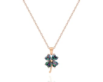 May include: A rose gold necklace with a four-leaf clover pendant featuring a multi-coloured gemstone.