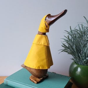 Wooden duck in a yellow raincoat wood carving cute duckies spring showers decor