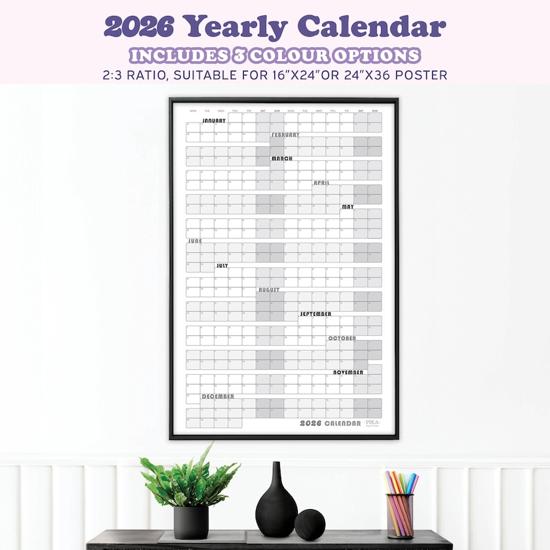 May include: A framed 2026 yearly calendar with a black border. The calendar includes the months of the year, with space for notes. The text at the top reads "2026 Yearly Calendar" and "Includes 3 Colour Options". The calendar is suitable for 16"x24" or 24"x36" posters.
