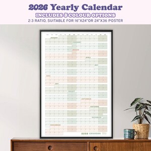 May include: A framed 2026 yearly calendar with a black frame. The calendar includes 3 color options and is suitable for 16"x24" or 24"x36" posters. The calendar displays the months of the year in a grid format, with each month having a different color.