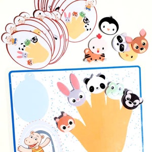 May include: A colorful finger puppet game with a yellow hand and various animal faces. The game includes a panda, rabbit, frog, squirrel, and bear. There are also separate animal faces for matching.