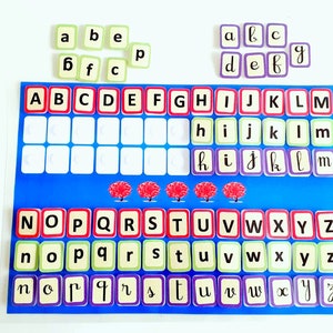 May include: A blue and white alphabet chart with red, green, and purple letter tiles. The chart has the letters of the alphabet in uppercase and lowercase. The tiles are arranged in rows and columns. The tiles are labelled with the letters A through Z.