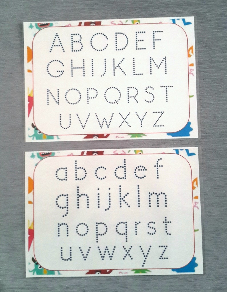 May include: Two white cards with a colorful border. The top card has the alphabet in uppercase letters, with each letter outlined in dotted lines. The bottom card has the alphabet in lowercase letters, with each letter outlined in dotted lines.