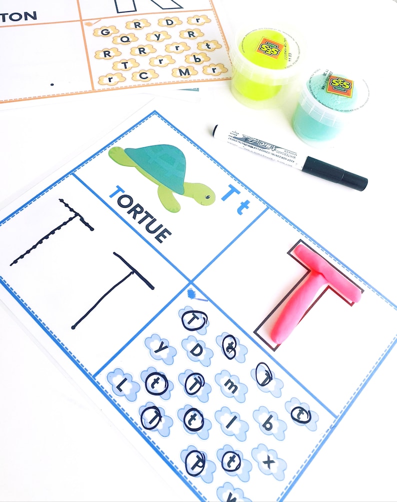 May include: A worksheet for learning the letter 'T' with a picture of a turtle, the word 'TORTUE', and the letter 'T' written in lowercase and uppercase. The worksheet also includes a section for tracing the letter 'T' and a section for finding the letter 'T' hidden among other letters.