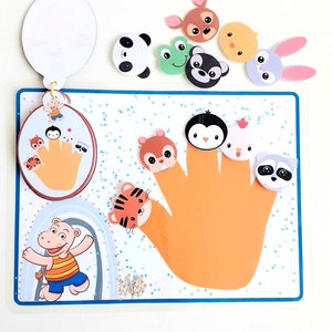 May include: A colorful felt finger puppet set with a variety of animal characters, including a panda, frog, penguin, chick, raccoon, squirrel, tiger, and bunny. The set includes a handprint template and a separate circle with a handprint and finger puppets.
