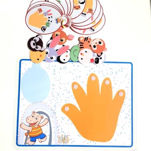 May include: A colorful educational game for children featuring a hand with five fingers and various animal characters. The game includes a blue and white board with a hand print and a set of animal cards.