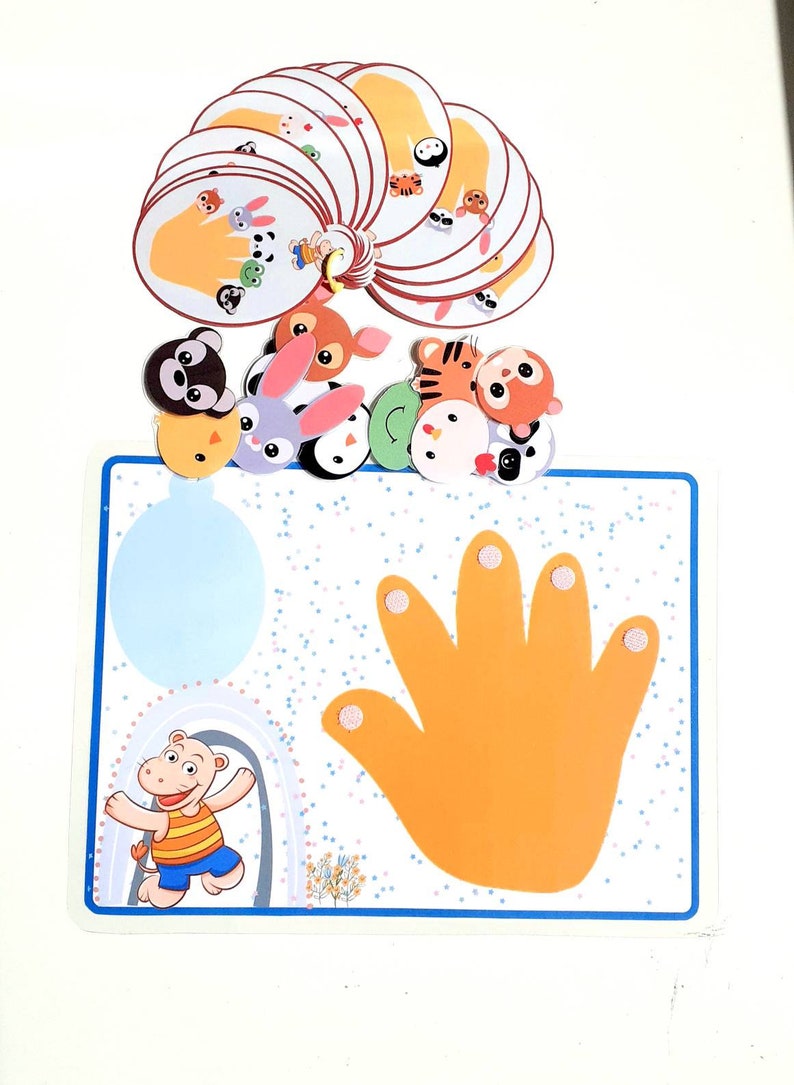 May include: A colorful educational game for children featuring a hand with five fingers and various animal characters. The game includes a blue and white board with a hand print and a set of animal cards.
