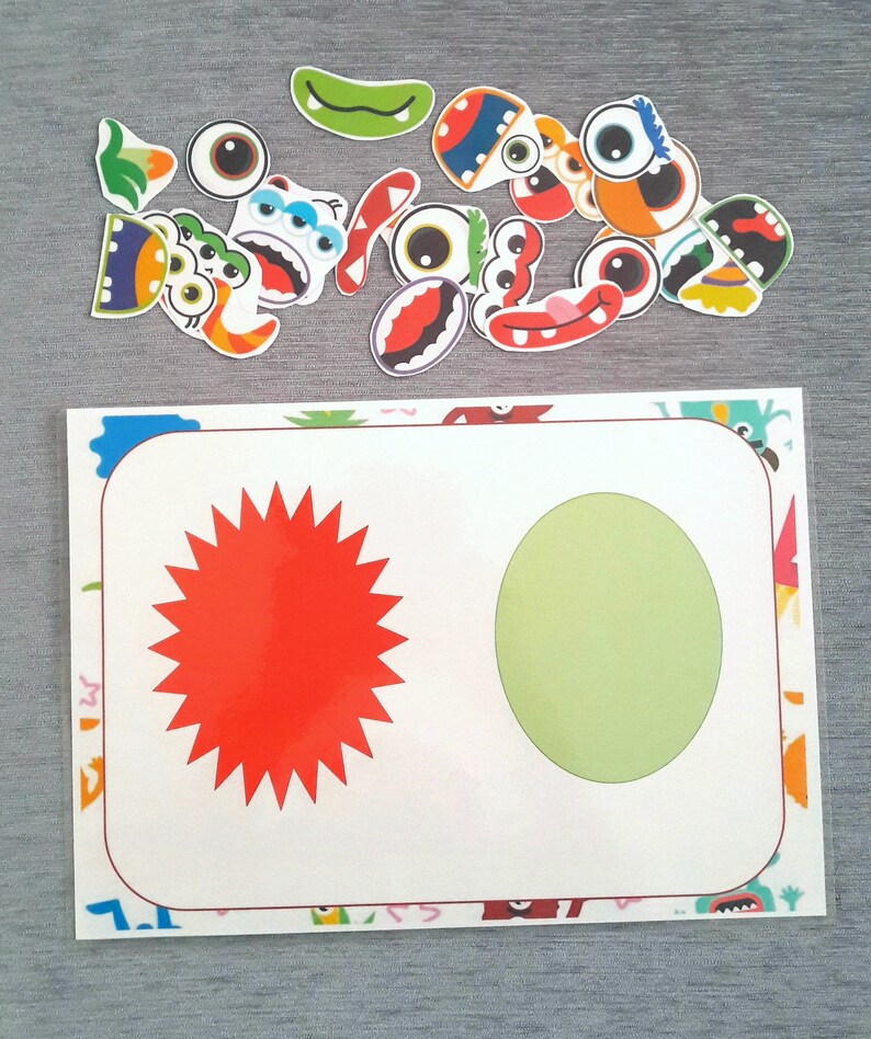 May include: A white card with a red star and a green circle on it. The card is surrounded by a border of colorful monster faces.