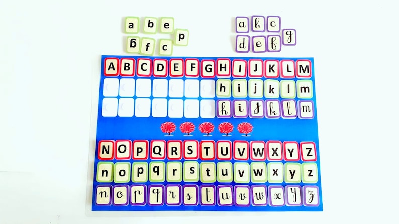 May include: A blue and white alphabet chart with red, green, and purple letter tiles. The chart has the letters of the alphabet in uppercase and lowercase. The tiles are arranged in rows and columns. The tiles are labelled with the letters A through Z.