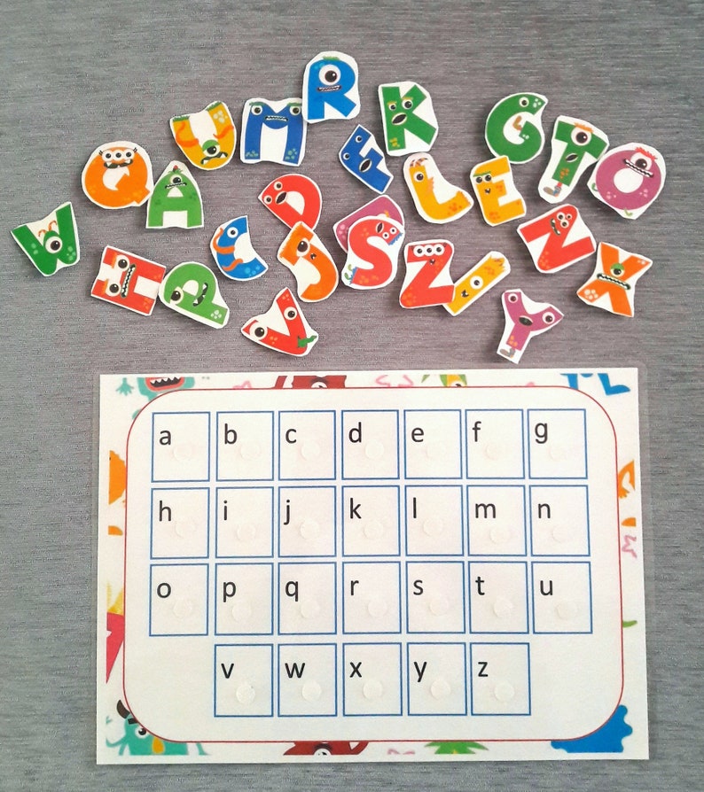 May include: A colorful alphabet learning chart with a grid of letters a-z. Each letter is in a separate square with a white circle in the center. There are colorful monster letters scattered around the chart.