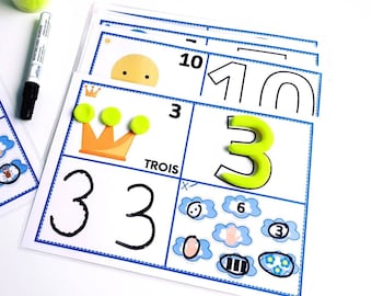May include: A set of printable worksheets for learning the number three. The worksheets feature a crown with three yellow playdough balls, the number three written in black marker, the word "TROIS" written in black marker, and a number three written in yellow playdough. The worksheets also feature a number three written in black marker, a number six written in black marker, and a number three written in black marker.