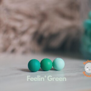 Three different shades of green 12mm silicone beads.