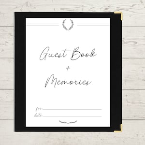 May include: Black guest book with a gold corner and a white page with the text "Guest Book + Memories" and a line for "for:" and "date:".