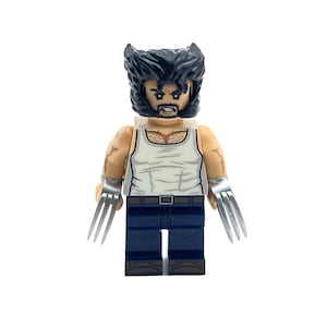 May include: A Lego minifigure of Wolverine, a superhero with claws, wearing a white tank top and blue jeans. He has a black and brown hairpiece and a printed face with a serious expression.