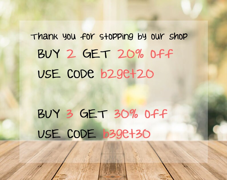 May include: A sign with a blurred background of green foliage. The sign says "Thank you for stopping by our shop. BUY 2 GET 20% Off USE CODE b2ge+20 BUY 3 GET 30% Off USE CODE b39e+30"