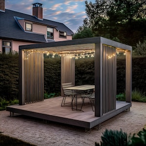 May include: A modern outdoor gazebo with a wooden deck and vertical slat walls. The gazebo features a table and chairs, and is illuminated by string lights. The structure is set in a garden with a house in the background.