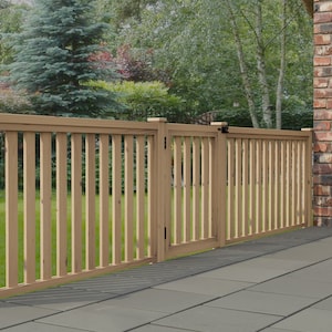 May include: A wooden fence with a gate, the fence is light brown and the gate is closed. The fence is in front of a brick wall and a green lawn.