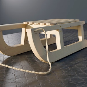 May include: A wooden sled with a rope attached. The sled is made of natural wood and has a simple design.