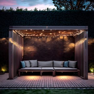 May include: A wooden outdoor pergola with a seating area. The structure has a dark brown frame with vertical slats and a slatted roof. The seating area includes gray cushions and blue accent pillows. String lights are draped across the top, and the scene is illuminated by warm lighting.