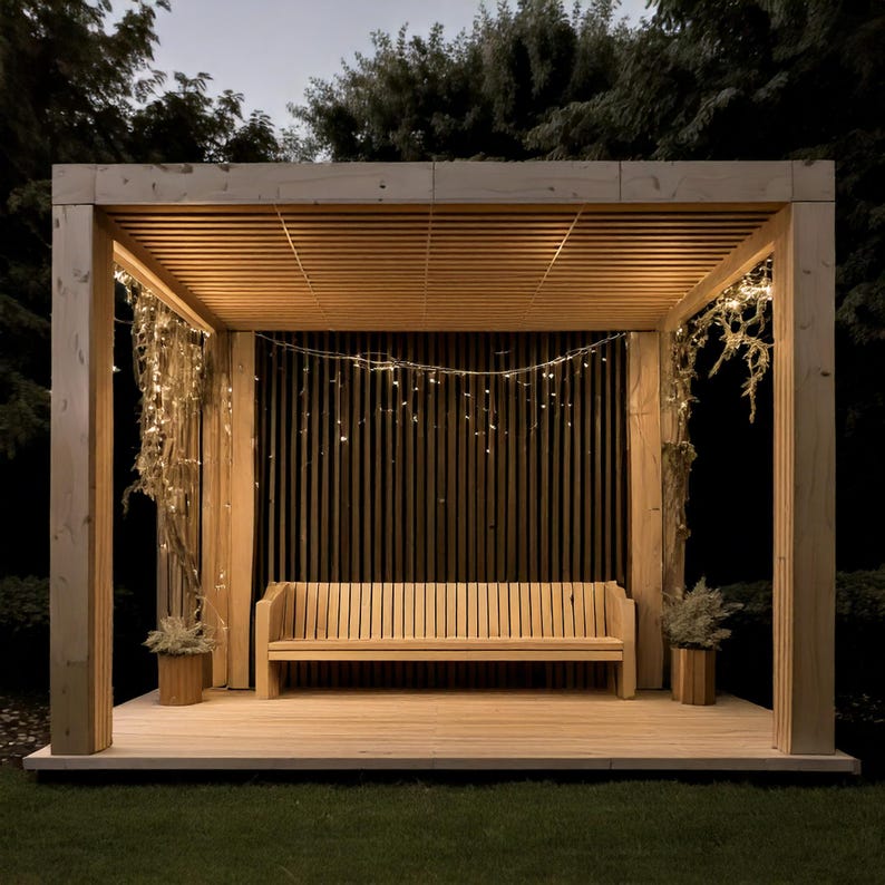 May include: A wooden pergola with a slatted roof and vertical back panel. A wooden bench sits inside the structure, with small potted plants on either side. String lights are draped across the top and sides, creating a warm, inviting atmosphere.