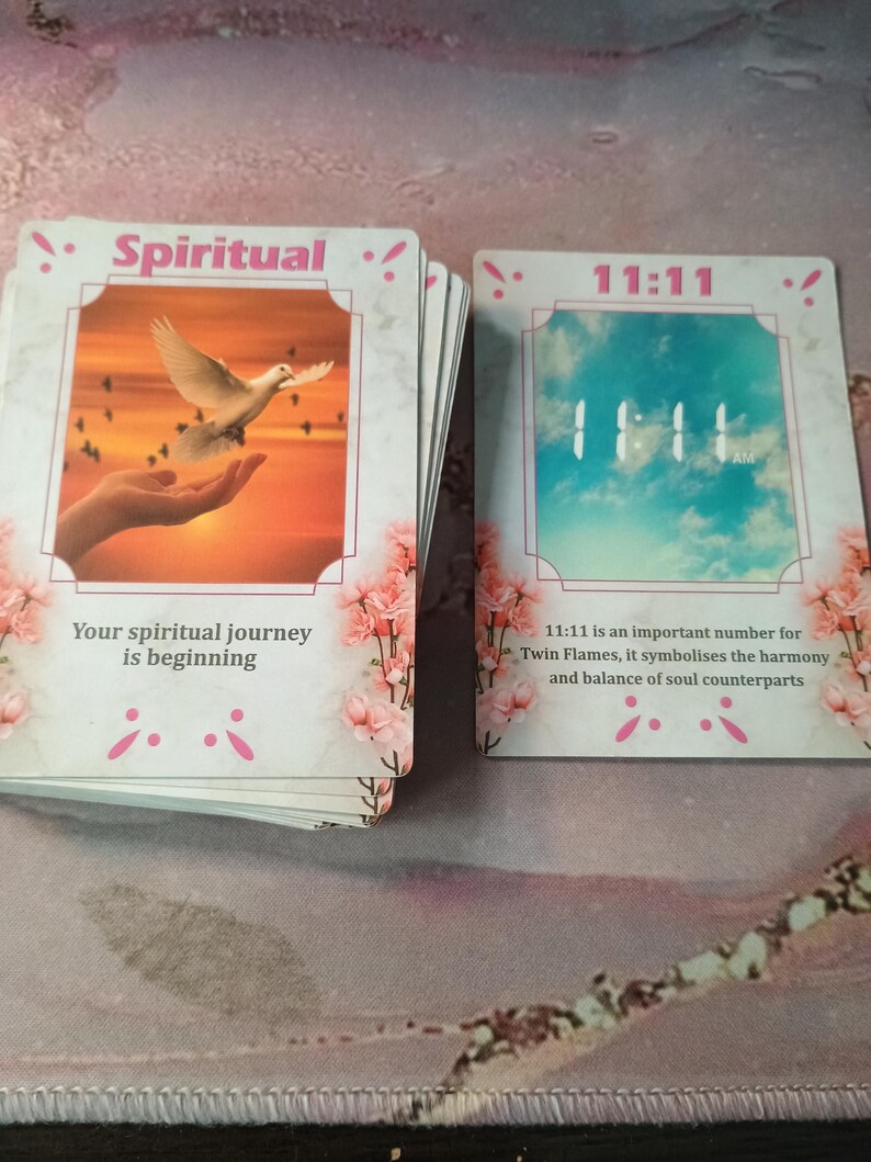 May include: Two cards with pink floral borders. The first card has a white dove flying over a sunset with the text "Spiritual!" and "Your spiritual journey is beginning". The second card has a blue sky with the text "11:11" and "11:11 is an important number for Twin Flames, it symbolises the harmony and balance of soul counterparts".